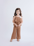 Little girl modeling a honey-brown and white vertical striped two-piece set featuring a layered ruffle camisole with a white flower accent and matching wide-leg pants.