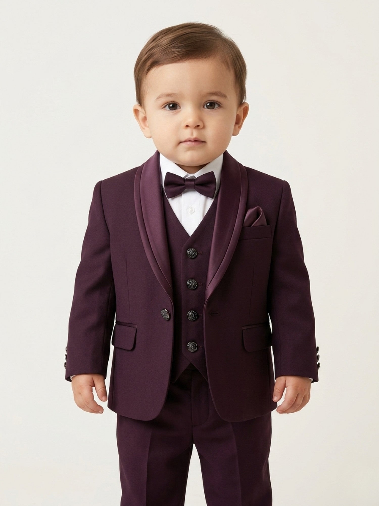 Baby boy wearing wine premium formal suit set with matching blazer, waistcoat, bow tie, and pants for partywear occasions.