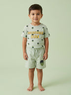 Young boy standing in a mint green two-piece cotton set featuring an Incredible Hulk printed t-shirt and matching shorts with a Hulk character graphic.