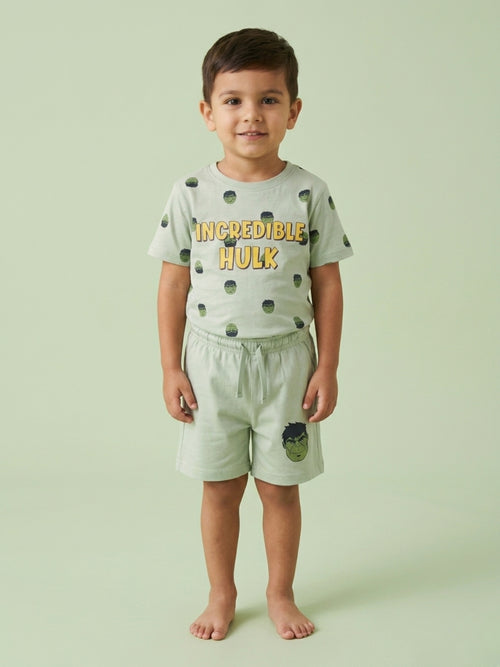 Young boy standing in a mint green two-piece cotton set featuring an Incredible Hulk printed t-shirt and matching shorts with a Hulk character graphic.