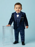 1-year-old baby boy wearing a navy blue sequin shimmer tuxedo blazer with a satin shawl lapel and a designer chain brooch