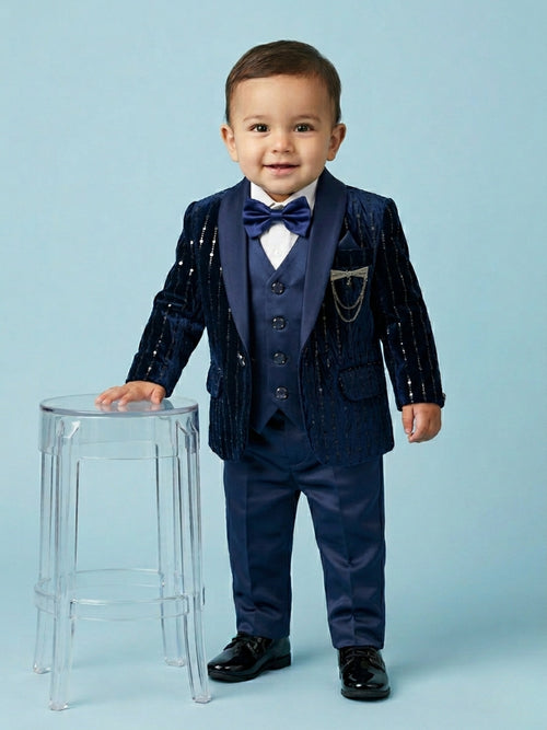 1-year-old baby boy wearing a navy blue sequin shimmer tuxedo blazer with a satin shawl lapel and a designer chain brooch