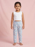 Little girl wearing sky blue cotton pajama pants with a colorful unicorn and rainbow pattern